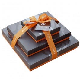 Stacked of chocolate boxes wrapped in a ribbon