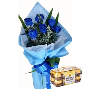 A boquet of blue roses and a box of Ferrero Rocher