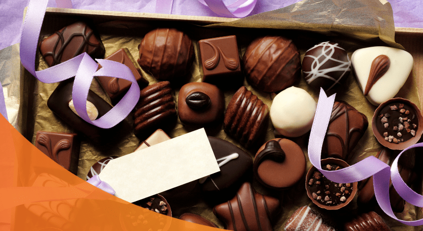 A box of chocolates with ribbon confetti